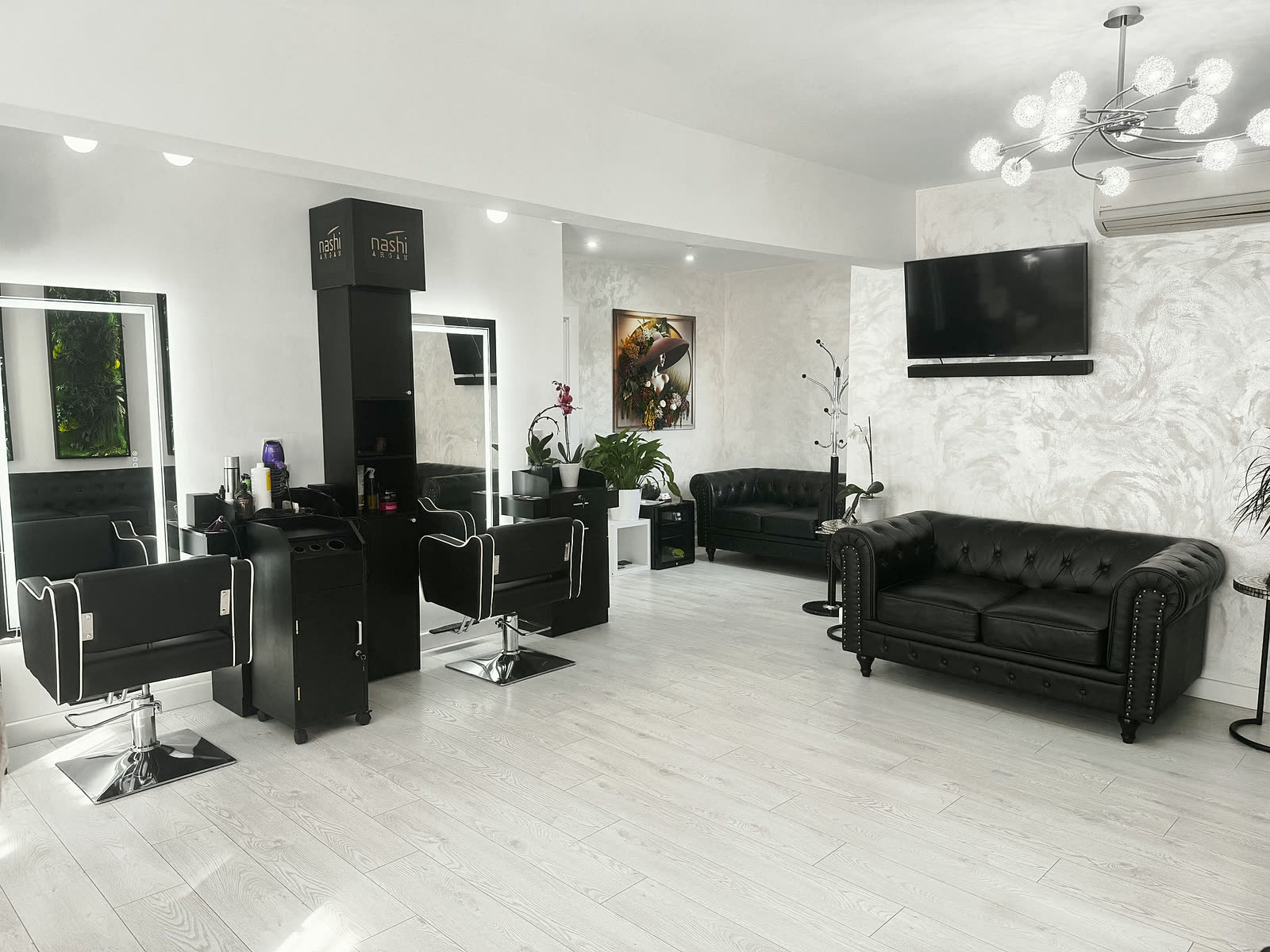 The lounge: styling chairs, mirrors and black chesterfield sofas